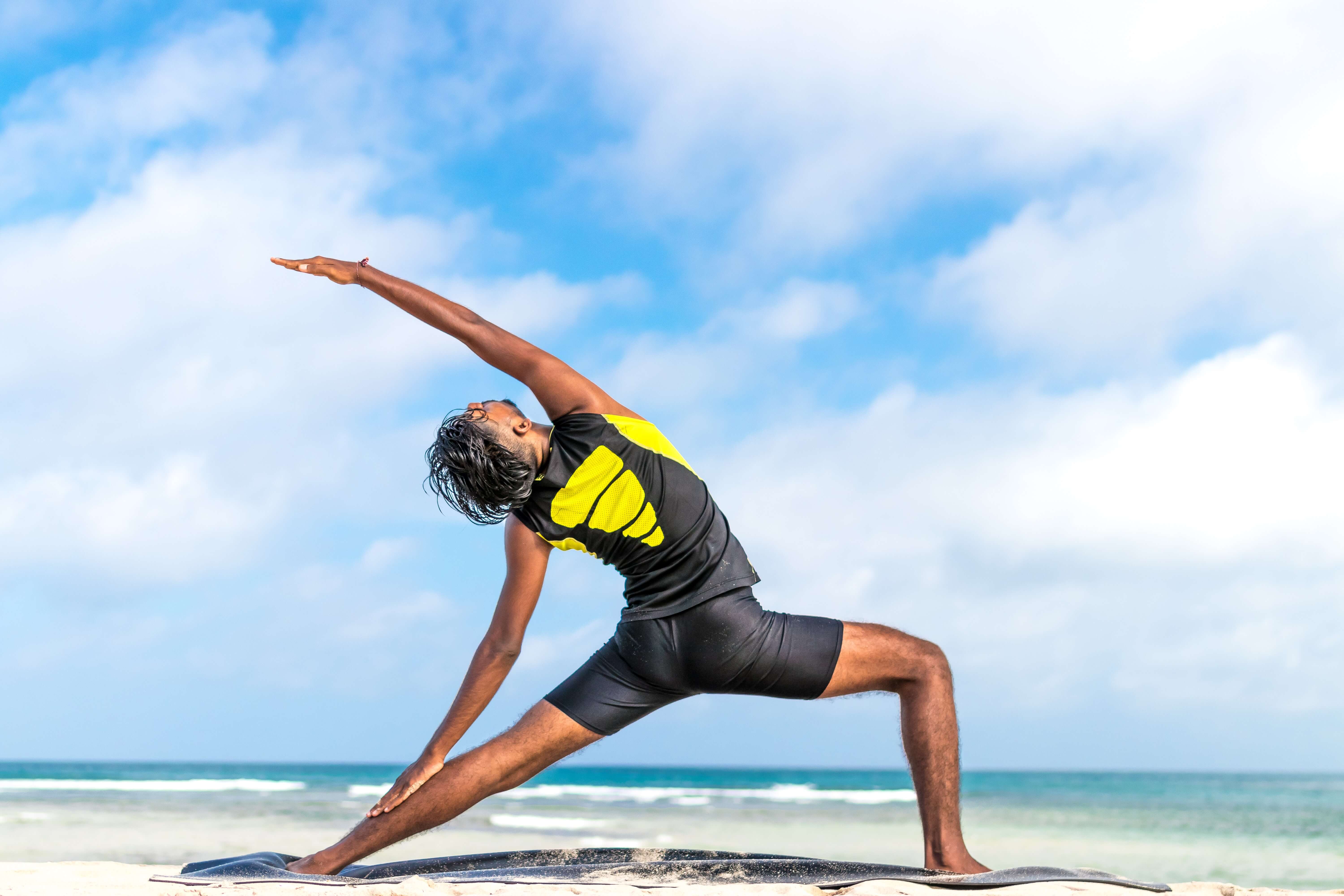 man stretching on beach