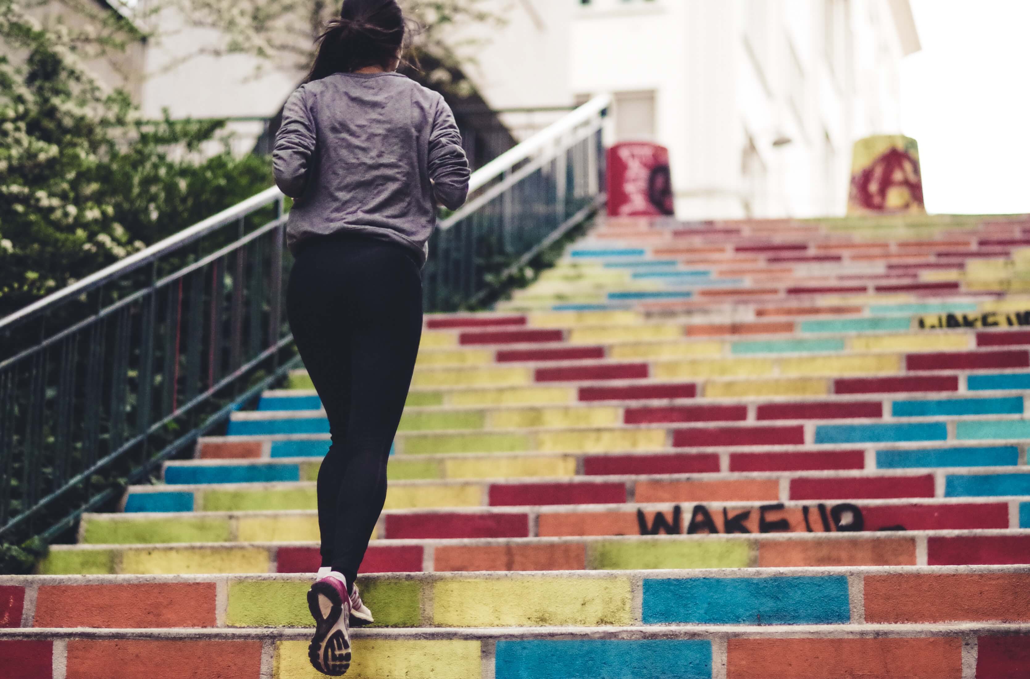 A girl runs up stairs