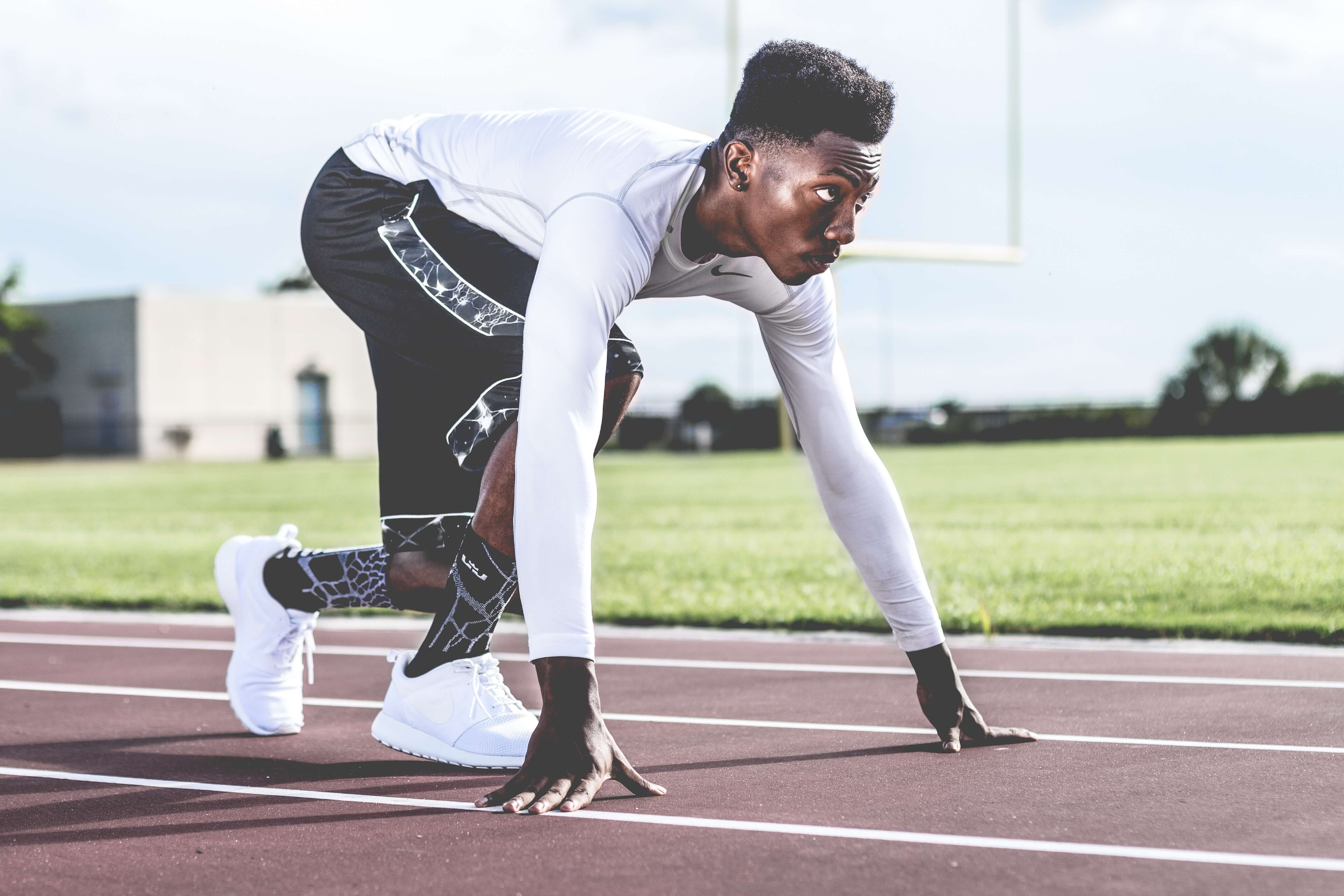 A male sprinter prepares to start race.