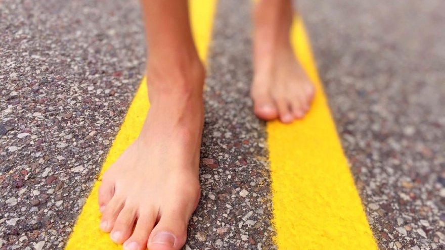 Barefoot runner: feet on the road