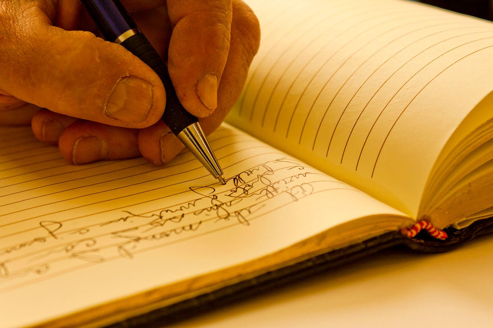 Man writing in a journal.