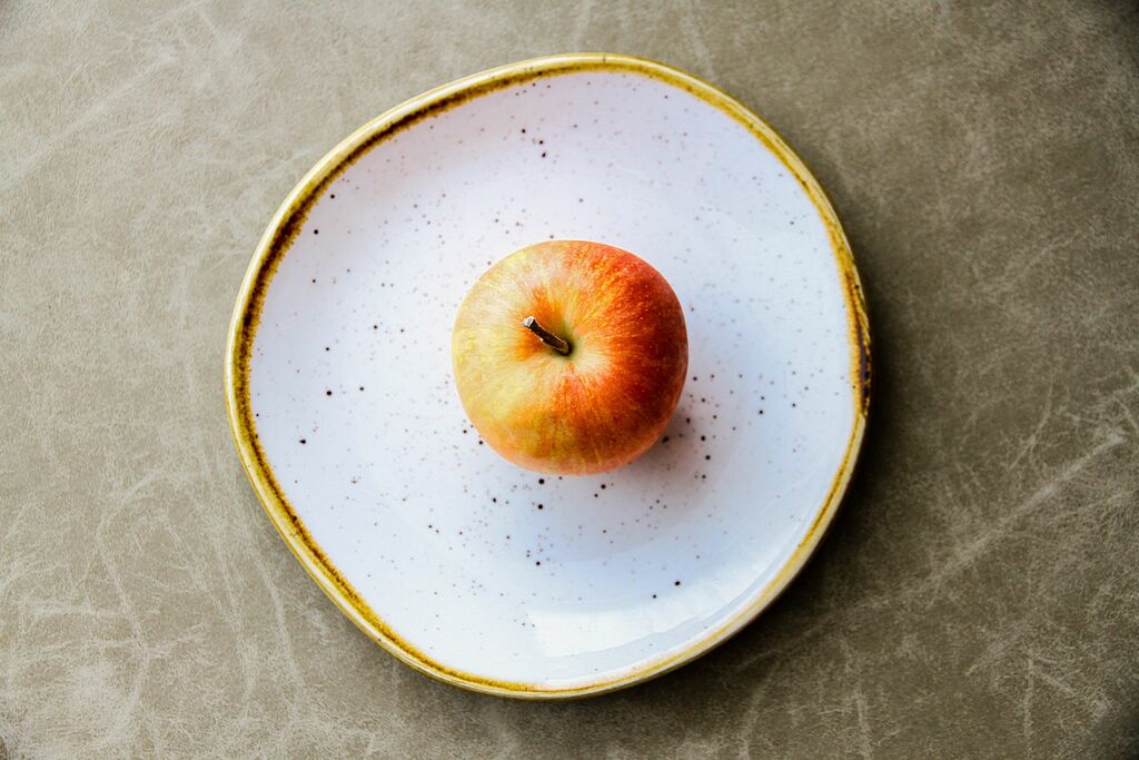 a single apple on a plate