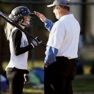 private trainer for baseball instructing a girl at practice
