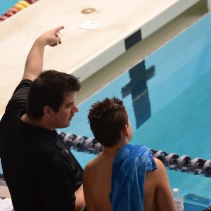private coach for swimming instructing a child at the pool